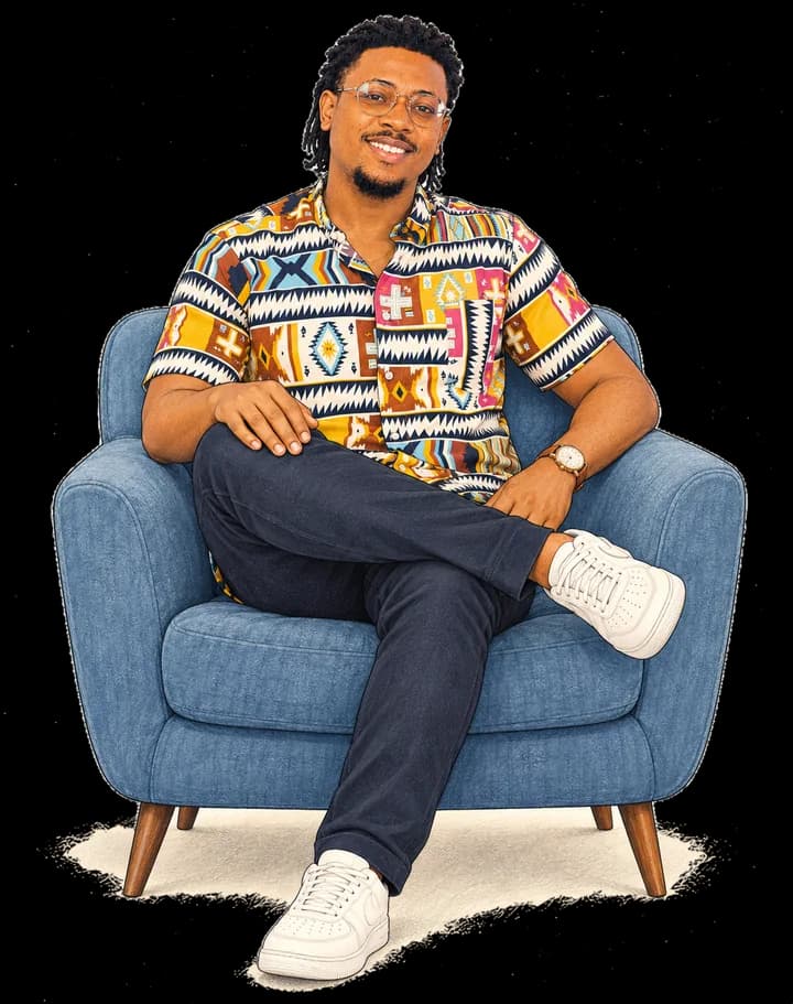 Terry, seated in an armchair, smiling.